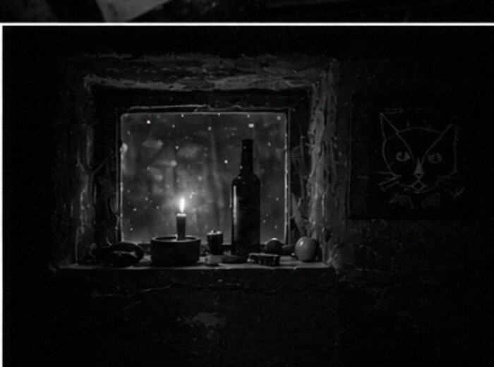 the two tiny windows — candle on the sill